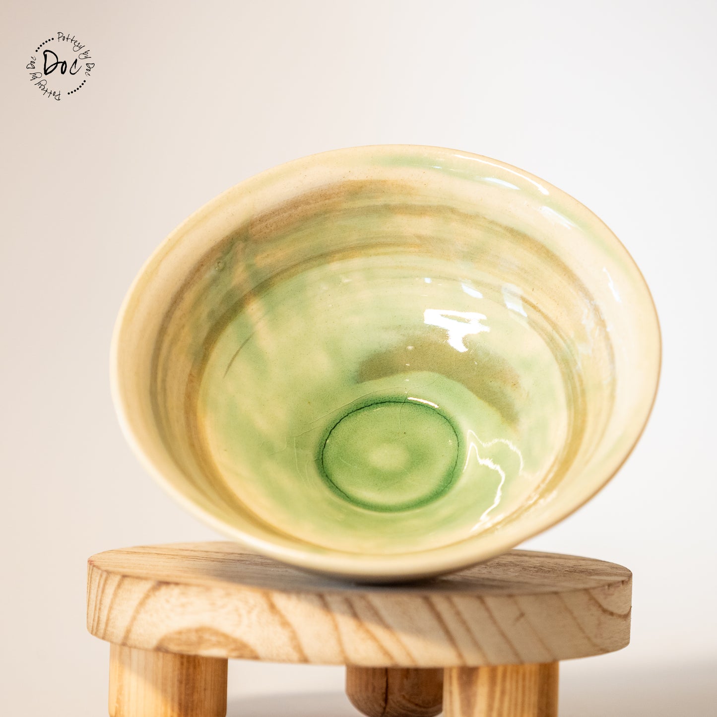 White and toffee marbled bowl with a hint of translucent green insicde