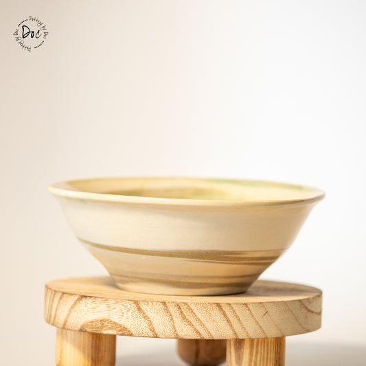 White and toffee marbled bowl with a hint of translucent green insicde
