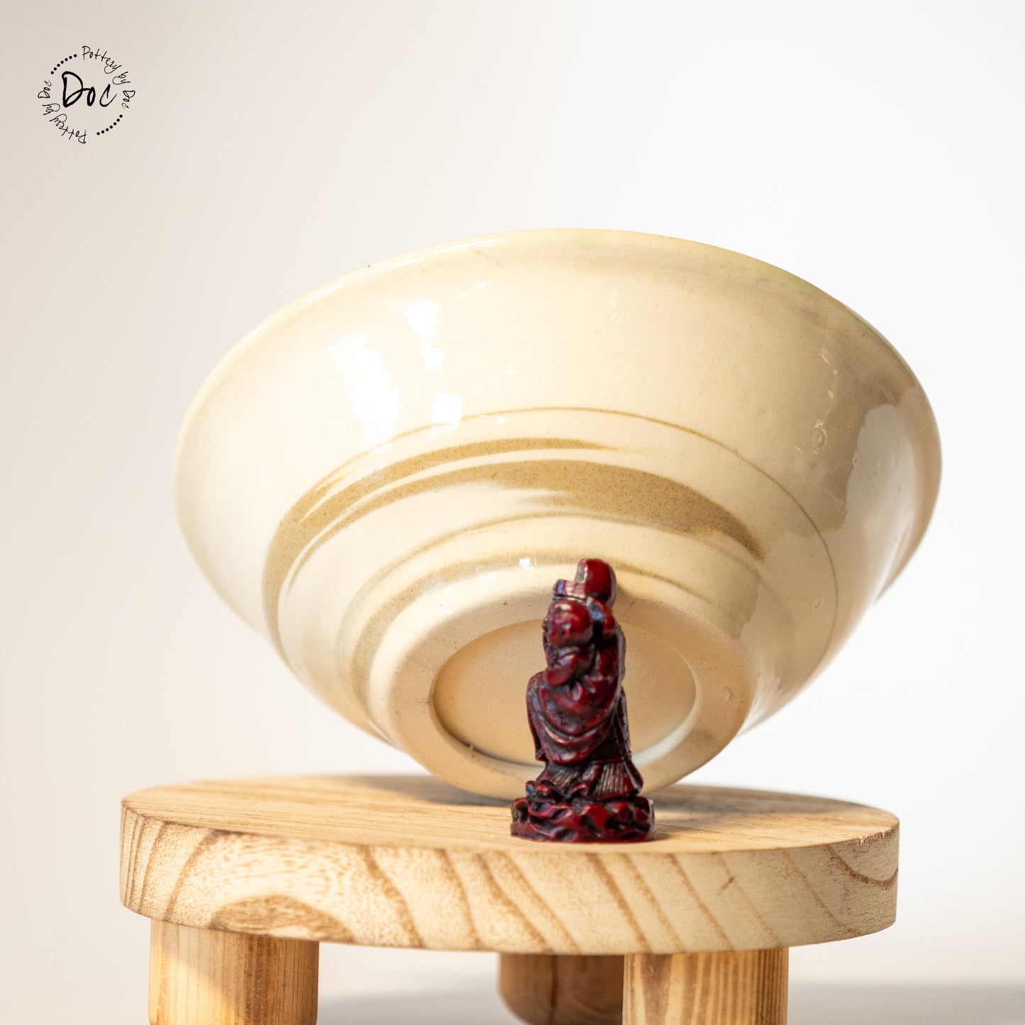 White and toffee marbled bowl with a hint of translucent green insicde